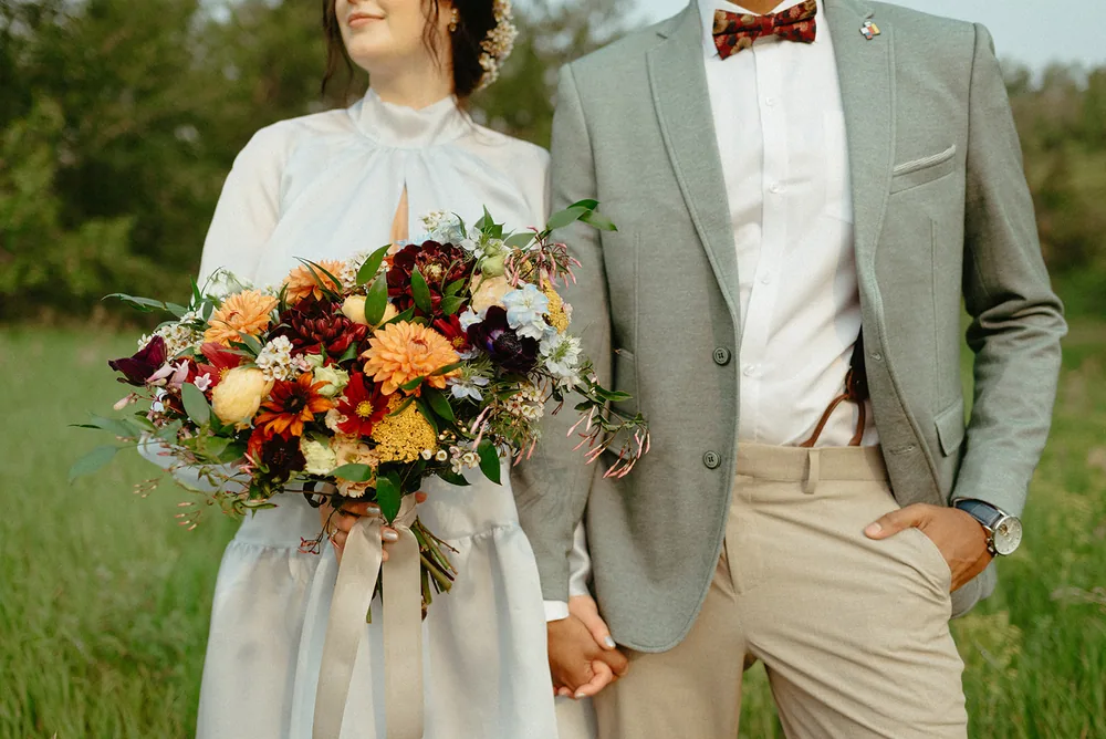 A forest ceremony framed by dried grasses and pampas