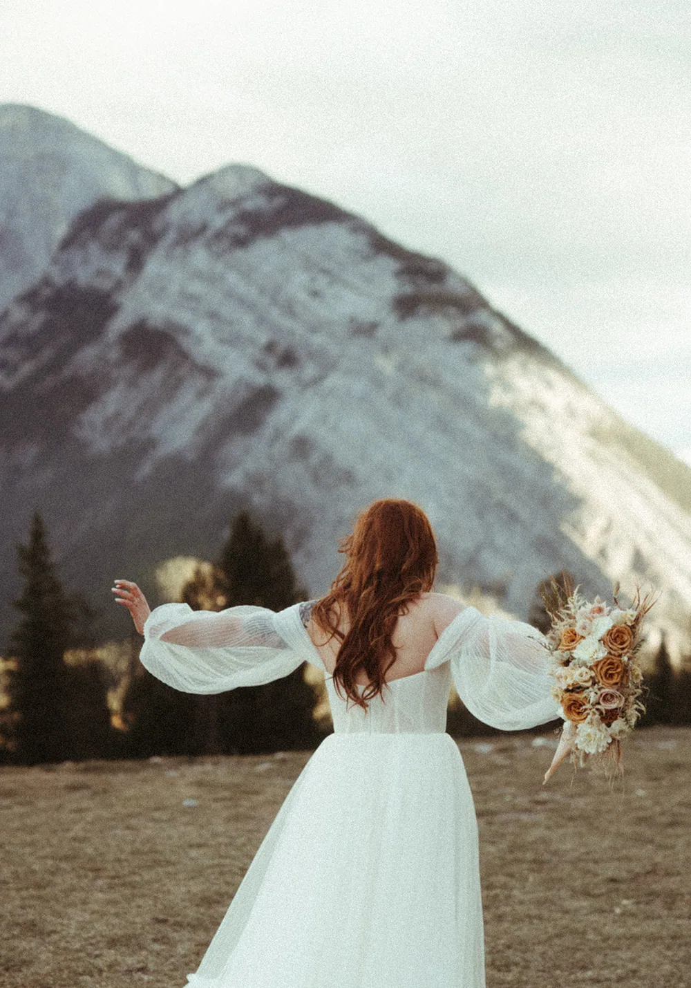 A forest ceremony framed by dried grasses